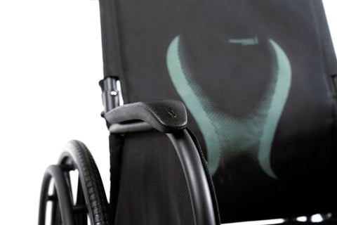 The ErgoSteel backrest with the ergonomic lumbar curve marked on the black upholstery, desk-length armrest in the foreground