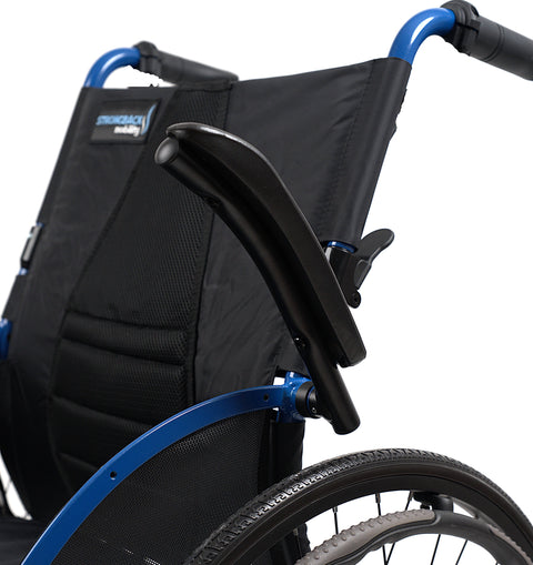 Close-up of the Strongback Comfort Flip armrest part way through its flip, swinging back and clear of the seat, with the contoured backrest and the blue frame behind it