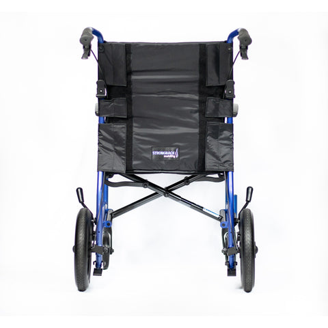 The Strongback Excursion transport chair seen straight on from behind, showing the padded backrest panel, both push handles with attendant brake levers and the folding cross brace
